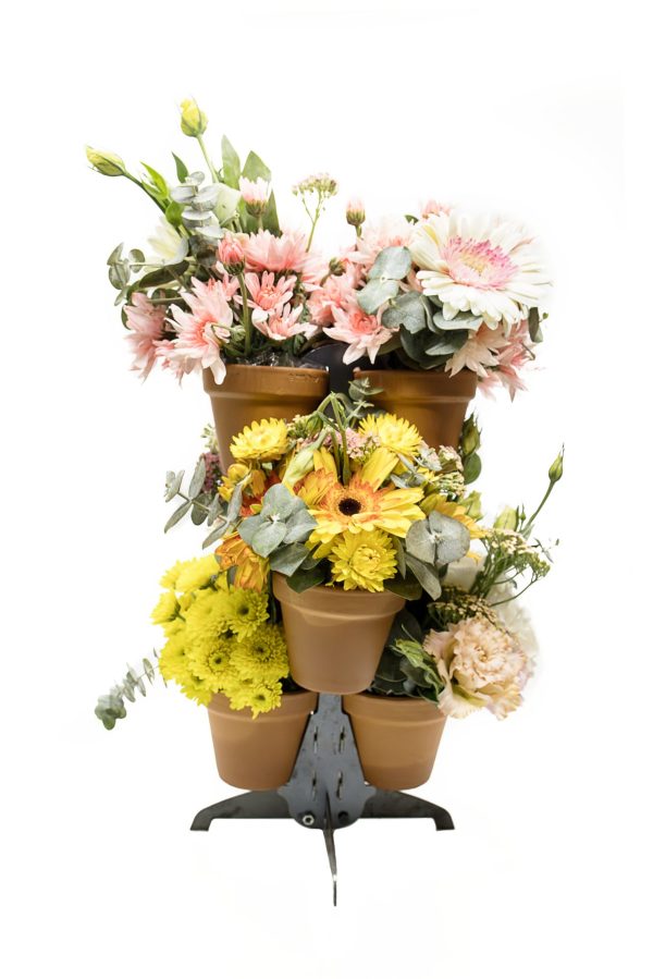 small plant stand with 6 pots displaying flowers.